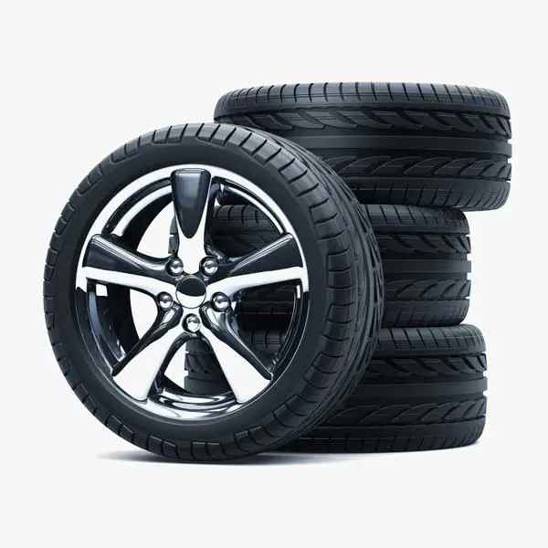 A new car tyre resting on three stacked tyres